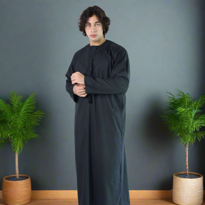 Man wearing a long black garment on a white background