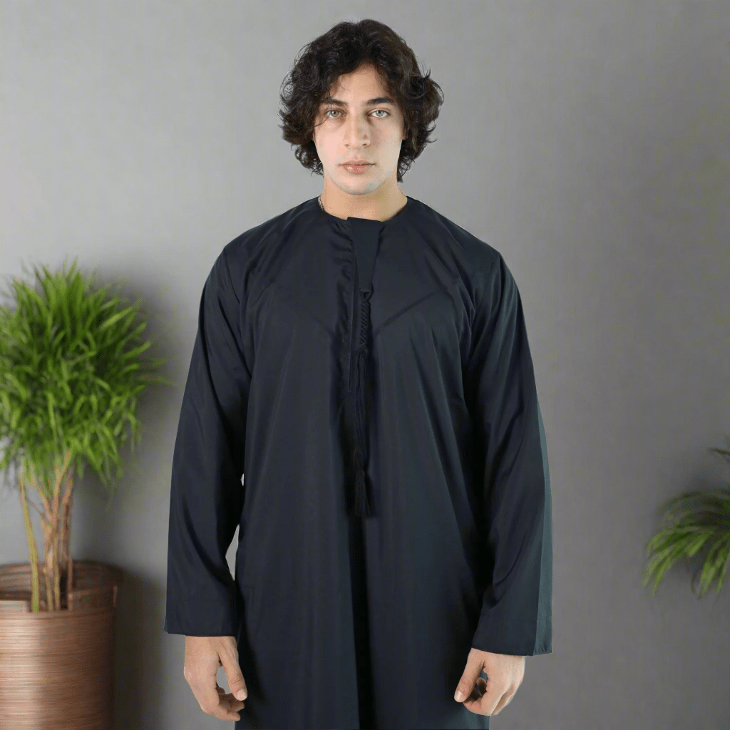 Man wearing a black long-sleeve garment against a light blue background