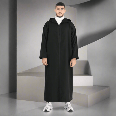 Man wearing a black abaya on a white background