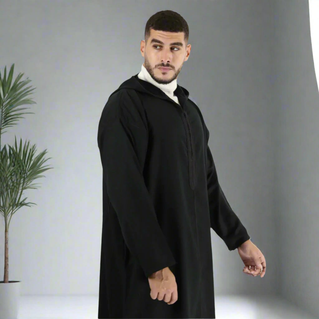 Man wearing a black abaya on a white background