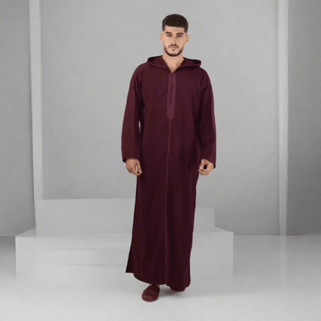 Man wearing a burgundy abaya on a white background