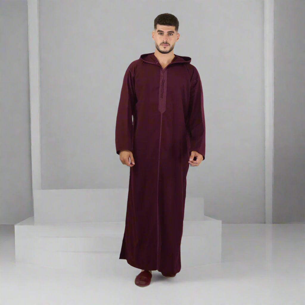 Man wearing a burgundy abaya on a white background