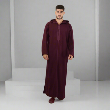 Man wearing a burgundy abaya on a white background