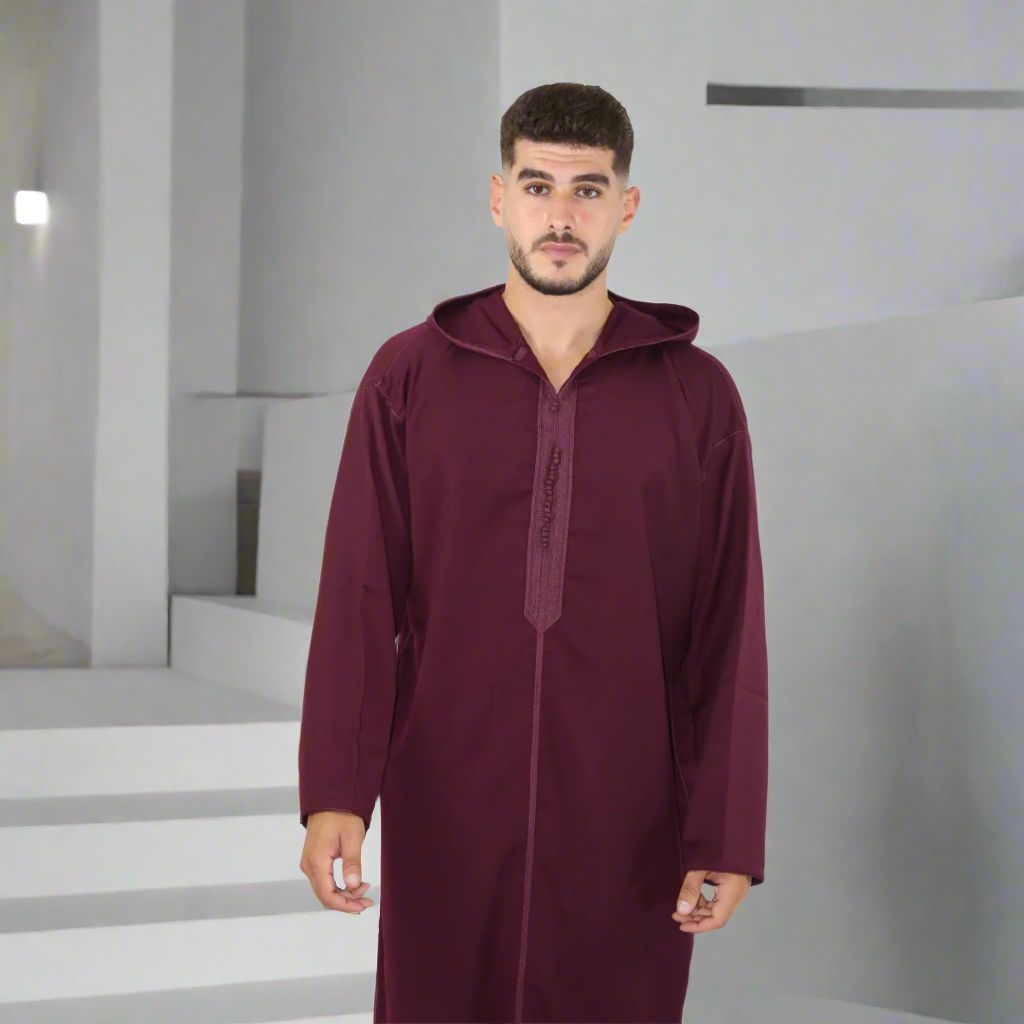 Man wearing a maroon hooded garment against a white background