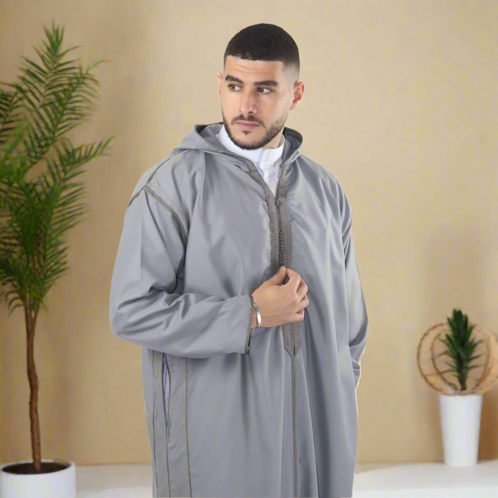 Man wearing a gray hooded coat on a white background