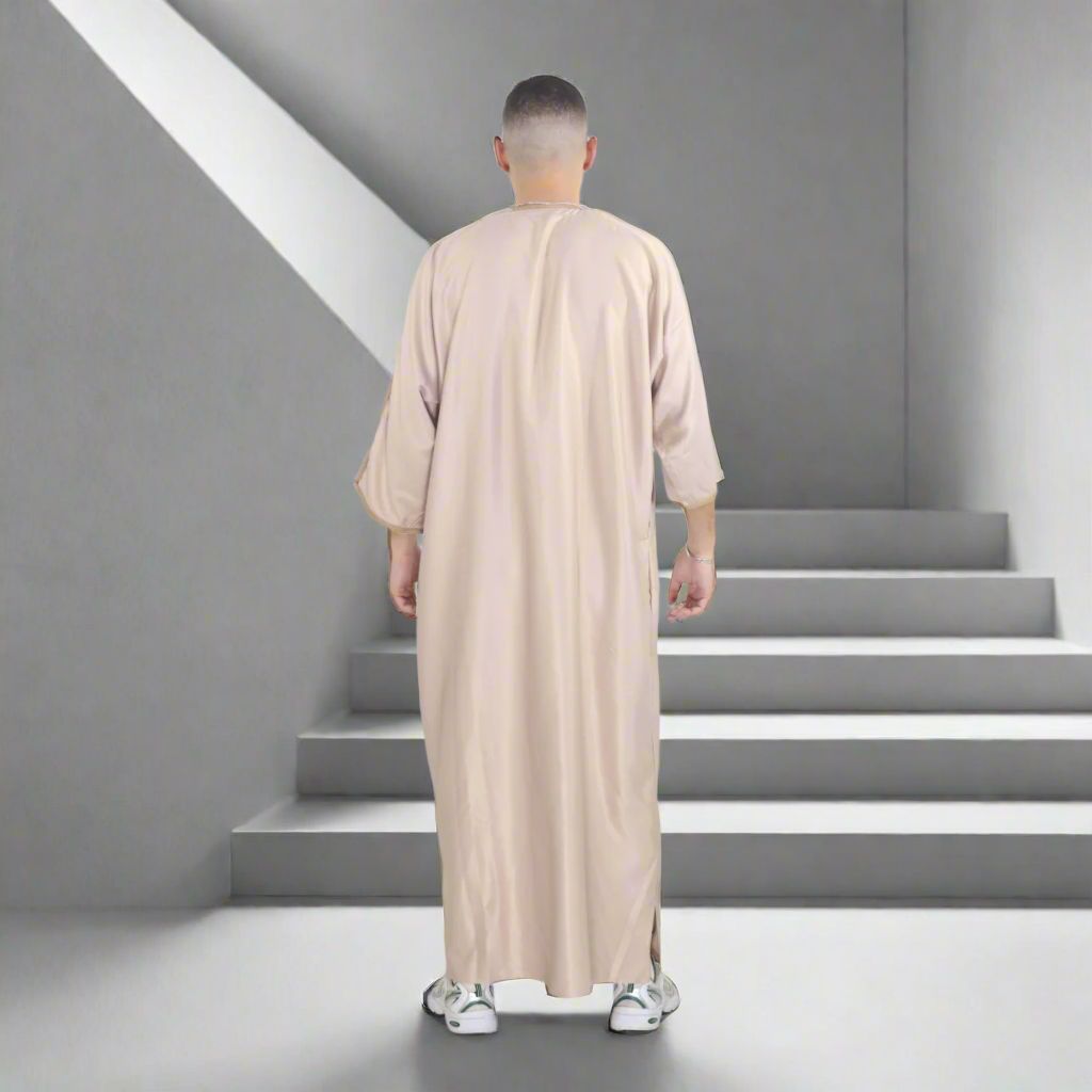 Person wearing a beige long garment on a white background
