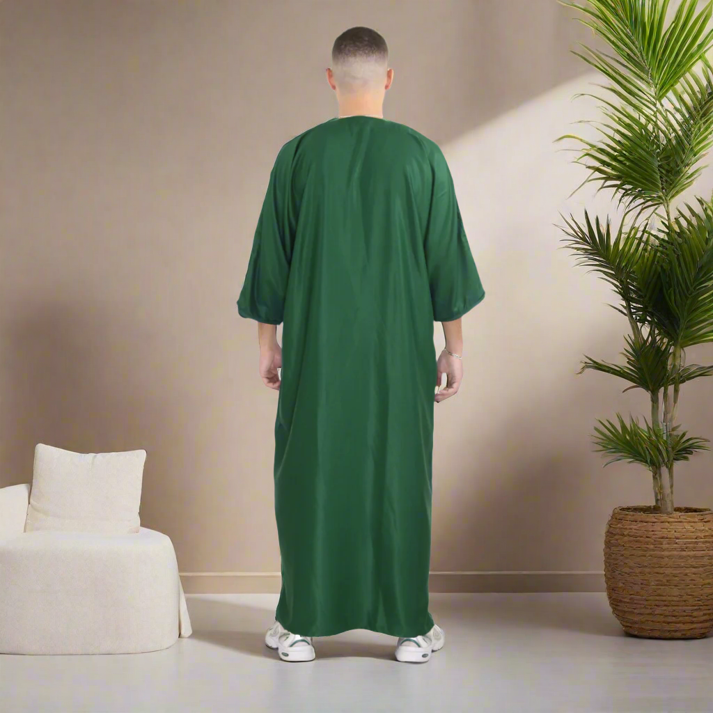 Person wearing a green abaya on a white background