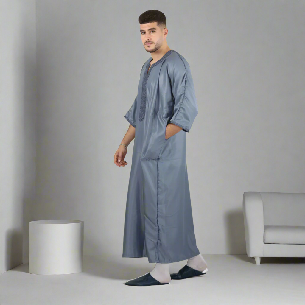 Man wearing a long gray garment on a white background