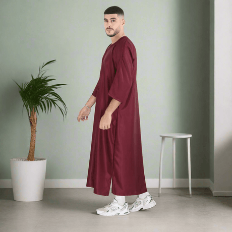 Man wearing a burgundy robe on a white background