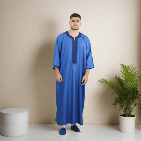 Man wearing a blue traditional outfit on a white background