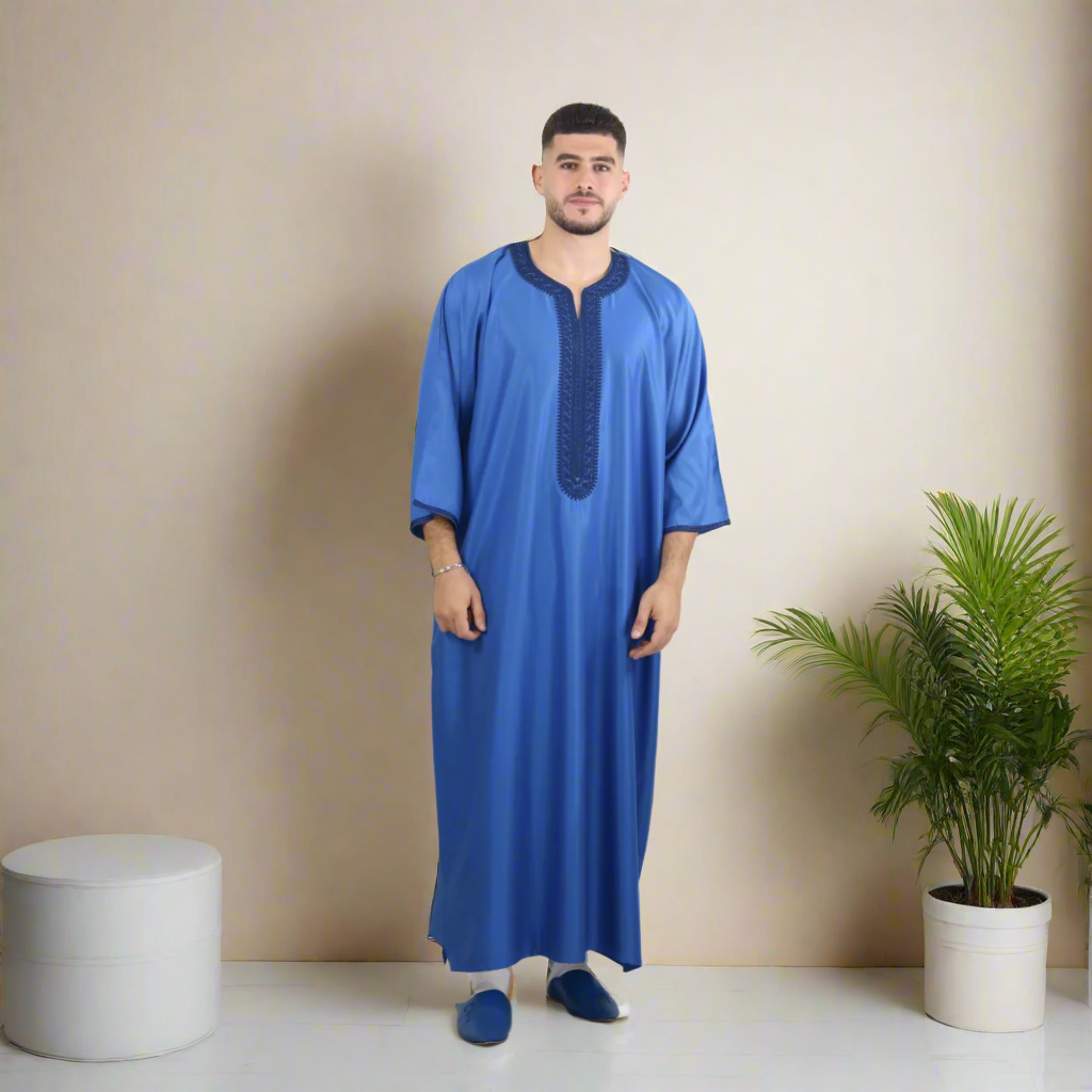 Man wearing a blue traditional outfit on a white background