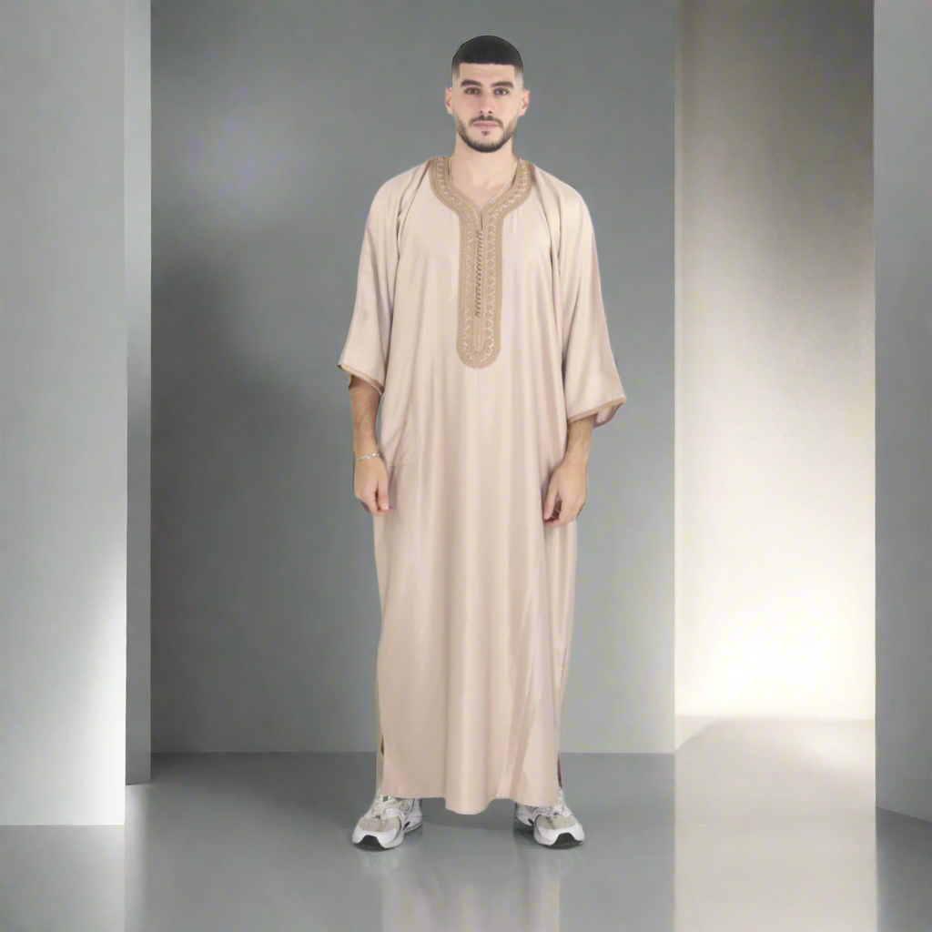 Man wearing a beige embroidered robe on a white background