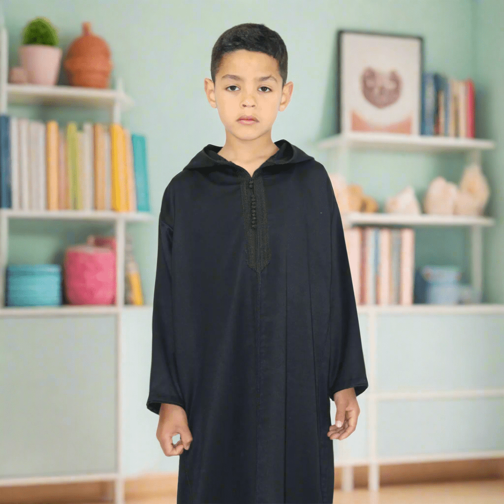 Child wearing a black hooded garment on a white background