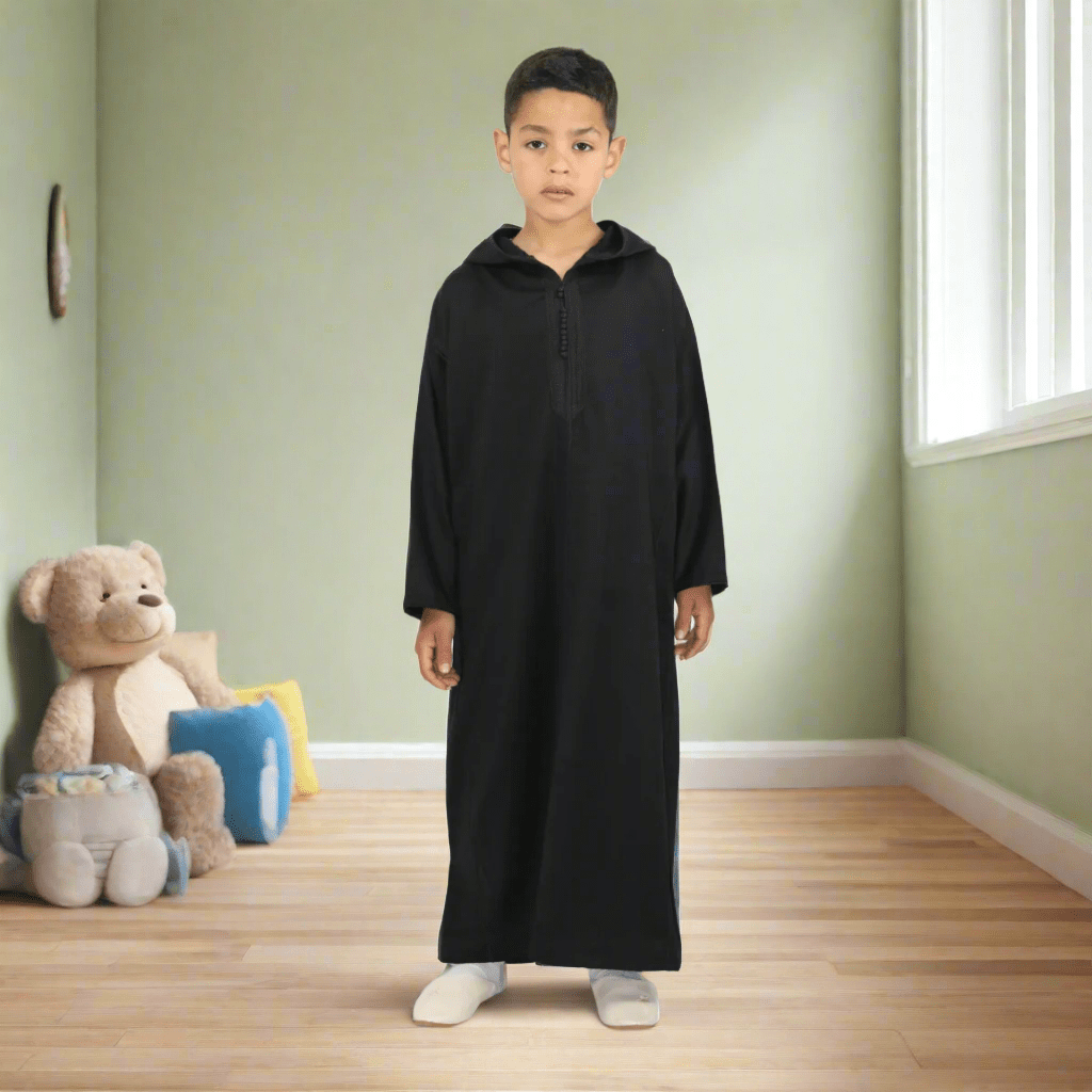 Child wearing a black hooded garment on a white background