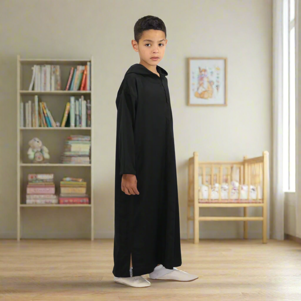 Child wearing a black abaya on a white background