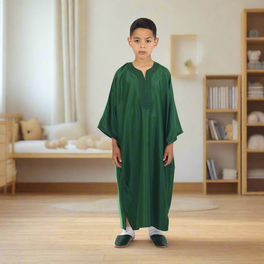 Child wearing a green robe on a white background