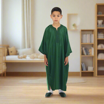 Child wearing a green robe on a white background