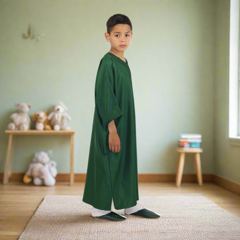 Child wearing a green robe on a white background